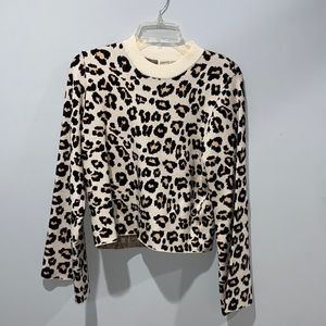 Leopard print sweater with flare sleeves. Lightly cropped
